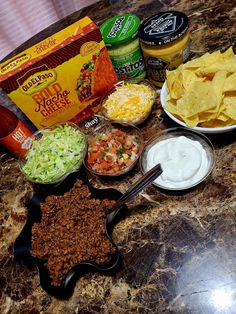 chips, salsa and other condiments on a counter