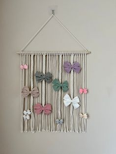 a wall hanging with several different colored bows on it