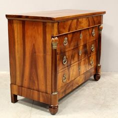 an antique chest of drawers with brass pulls and knobs on the top, inlaid to wood