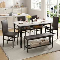 a dining room table with four chairs and a bench