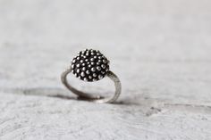 Dot ring-Sterling silver bubble ring-Statement ring-Granulation -Polka dot ring-Women's ring-Organic jewelry -Minimalist ring-Gift for her Sterling silver dot ring featuring an adjustable texture band with a circle full of bubbles ! The finish is matte and oxidized just to help the bubble effect stand out. This ring has been made using the lost wax method, an ancient technique to create jewelry. Minimal and organic Sterling silver ring! -The ring is adjustable,but please select your ring size for a perfect fit. -MATERIAL- Sterling silver  Every piece you purchase from Cyklu is unique and handmade with love and affection. Caring instructions: As the ring are made from sterling silver, please keep them in a box or pouch, to avoid darkening. In such a case they can be easily cleaned, with a s Stackable Sterling Silver Dome Ring, Sterling Silver Stackable Dome Ring, Unique Everyday Sterling Silver Rings, Unique Sterling Silver Round Band Ring, Handmade Promise Rings, Handmade Minimalist Sterling Silver Dome Ring, Handmade Dome Promise Ring, Modern Rings With Oxidized Finish For Gifts, Minimalist Round Oxidized Jewelry