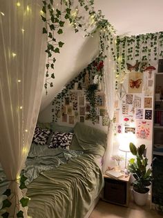 an unmade bed with ivy growing on the walls and curtains over it's headboard