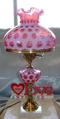 a pink and gold table lamp with hearts on it