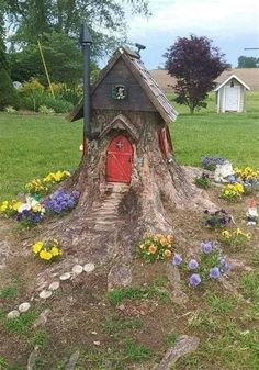 a tree stump with a house built into it