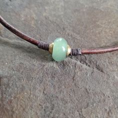 This may be the gift you are searching for.  Minimalist and earthy men's, women's or unisex semiprecious gemstone on leather choker necklace. I placed a nice large Green Aventurine gemstone rondelle bead on substantial 3mm brown leather cord and enclosed it on both sides with brass spacer beads.  These beads are all secured in place with waxed cord wrapped in a complimentary fashion, adding to the earthy natural style of this piece.   This necklace is casual and natural and easy to wear.  It has Cheap Adjustable Cord Choker, Everyday Waxed Cord Jewelry With Sliding Knot, Everyday Jewelry With Sliding Knot In Waxed Cord, Casual Aventurine Jewelry For Gifts, Everyday Necklaces With Sliding Knot And Waxed Cord, Brown Waxed Cord Jewelry For Healing, Boho Surfer Style, Leather Necklace Diy, Leather Cord Jewelry