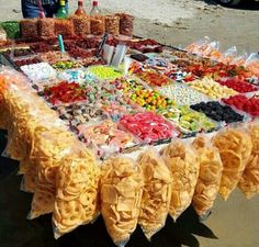 a table covered with lots of different types of food on display in front of people