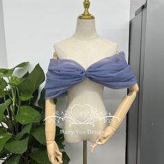 a mannequin with a blue bow on it