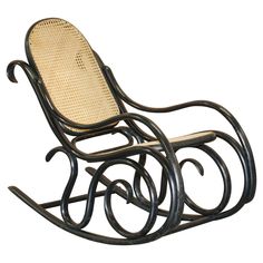 a wooden rocking chair with wicker seat and backrests on an isolated white background