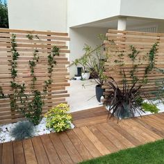 a wooden fence with plants growing on it