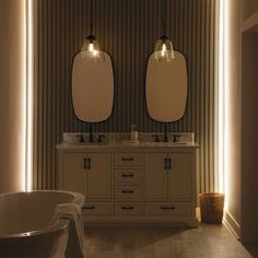 a bathroom with two sinks and a tub in it