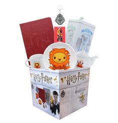 a harry potter themed gift box filled with hogwart's dinnerware and books