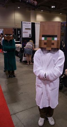 a person wearing a paper bag over their head and standing in front of a booth