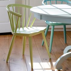 two chairs sitting next to each other on top of a hard wood floor in front of a white door