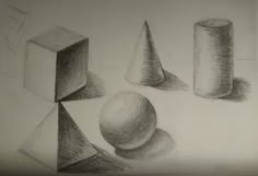 pencil drawing of three different shapes and sizes on white paper, with one ball in the foreground