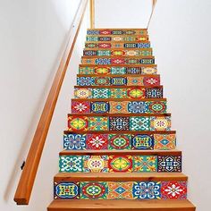 the stairs are decorated with colorful tiles and wooden handrails