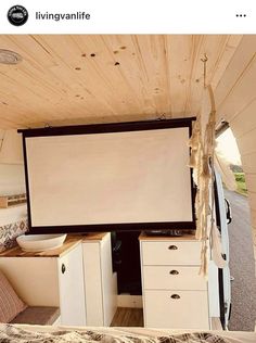 the interior of a camper with a flat screen tv on it's wall