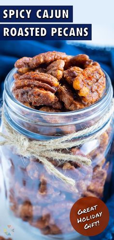 spicy cajun roasted pecans in a glass jar with text overlay that reads, spicy cajun roasted pecans great holiday gift