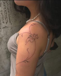 a woman's arm with a tattoo on it that has a flower in the shape of a heart