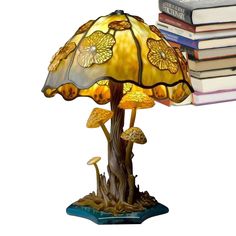 a lamp that is sitting on top of a book shelf next to a stack of books