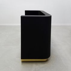 a black trash can sitting on top of a white floor