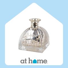 a glass bottle that is sitting on top of a blue and white background with the words at home written below it