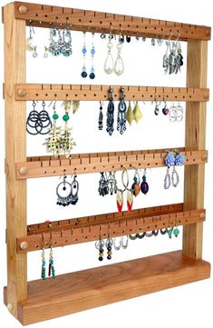 a wooden rack with earrings hanging from it's sides and two rows of earring hooks on each side