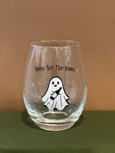 there is a glass with a ghost on it that says, we're for the boos