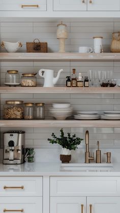 the shelves in this kitchen are filled with dishes, cups and other things to eat