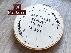 a hand embroidered hoop with the words hey there demons it's me ya boy