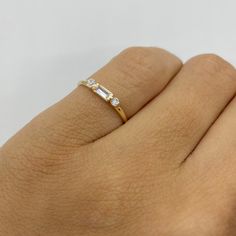 This 14k dainty ring three stone ring has a baguette diamond simulant center stone (CZ) and two round CZ stones on either side. This is a great option if you're looking for a slim pinky ring. It's a beautiful ring for a baby, a child, or the perfect size for a woman's pinky finger or a slender ring finger.    * Solid 14K Gold  * AAAA Quality Cubic Zirconia Stones   * Small sized ring  Visit us on Instagram @agoldmindjewelry for o ur custom jewelry designs and newest listings ▬ All jewelry pieces Small Pinky Ring, Pinkie Finger Ring, Ring Designs For Index Finger, Dainty Pinky Ring, Pinky Ring Women, Gold Pinky Ring Women, Pinky Finger Ring Women, Pinky Ring Stack, Pinkie Rings For Women