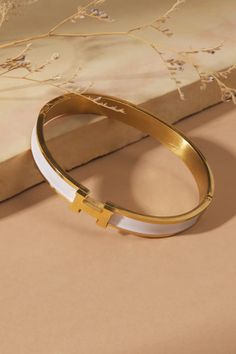 Embrace timeless elegance with this delicate gold bangle. This bracelet will make a cherished addition to your everyday style. Delicate Gold Chain, Hermes Bracelet, Preppy Jewelry, Clover Bracelet, Cuff Bangle Bracelet, Gold Bracelet For Women, Gold Cuffs, Jewelry Lookbook, Gold Bangle