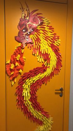 a door decorated with red and yellow paper dragon decorations on it's front doors