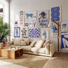 a living room filled with furniture and pictures on the wall