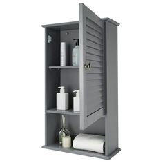 an open gray cabinet with towels and toiletries on the shelf next to each other