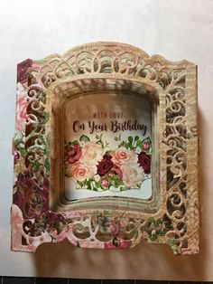 an ornate wooden frame with flowers on it and the words happy birthday written in cursive writing