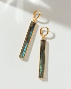 These earrings feature oblong, vibrantly colored gemstones, each faceted to showcase their unique hues and natural striations. Designed for style and comfort, the huggie hoop fit guarantees secure wear, ensuring these beauties stay in place. Not only do they offer an effortless, eye-catching look, but they also come with a story – the significance of each gemstone adds a layer of depth and intrigue, setting you apart from the crowd. Despite their substantial appearance, these earrings are surpri