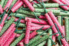 many pink and green sticks are on the table