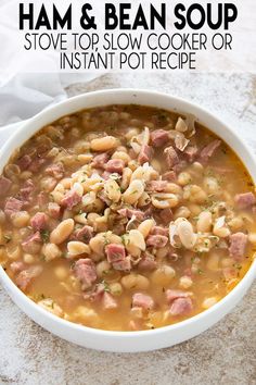 a white bowl filled with ham and bean soup sitting on top of a marble counter