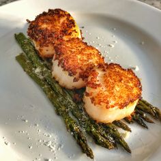 scallops and asparagus on a white plate