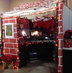 a room decorated for christmas with stockings and stockings on the fireplace, lights around the fire place