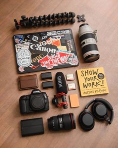 the contents of a camera sitting on top of a wooden table next to other items