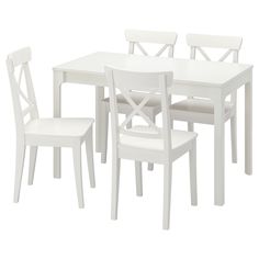 a white table and four chairs are shown