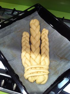 some kind of food that is on top of a stove burner and has been made to look like braids