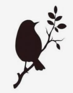 the silhouette of a bird sitting on a branch with leaves in it's beak