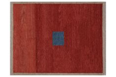 a red rug with a blue square in the middle