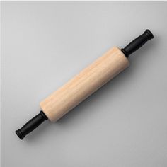 a wooden handle with black handles on a gray background