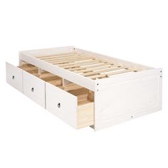 a white bed with two drawers underneath it