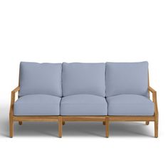 a wooden couch with light blue cushions on top of the back and side ends, against a white background