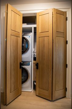 an open door to a washer and dryer in a room