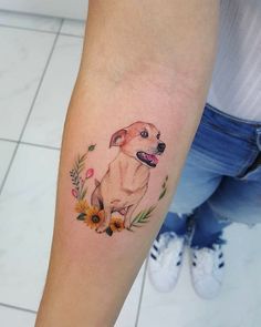 a woman with a dog tattoo on her arm